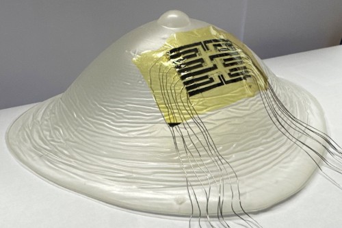 The ultra-thin temperature-sensing patch shown on a model breast.